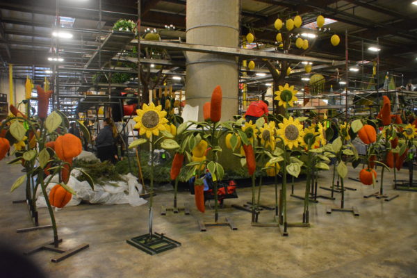 Sunflowers and tomatoes on tall stalks made with organic materials including seeds