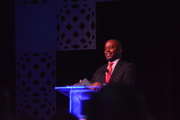 State Superintendent of Education Tony Thurmond smiles from the lectern during opening remarks