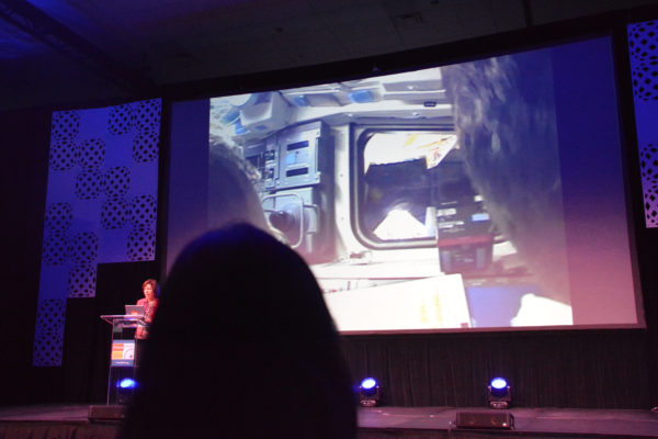 Dr. Ellen Ochoa shows a slide ot Atlantis docking with the ISS at California STEAM Symposium 2019