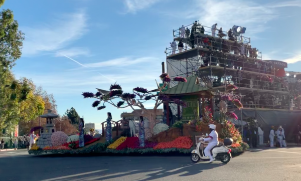 Downey Rose Float, depicting a Japanese garden with cranes, passes the reviewing stand