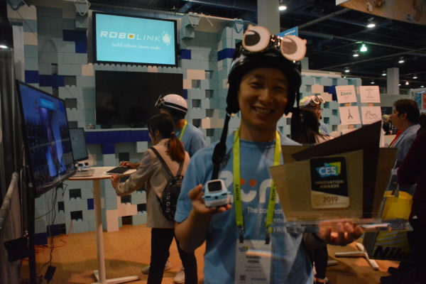 Robolink CEO Hansol Hong holds Zumi robot and Best of CES award on show floor of CES 2019