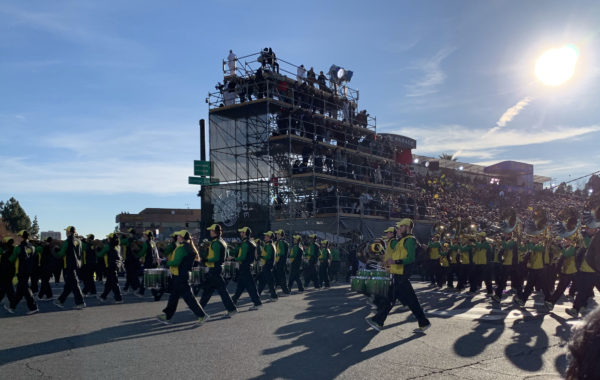 Oregon band in green and gold uniforms with drums