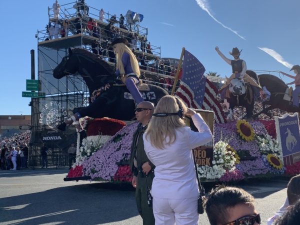 Hope Ride Rodeo float appears, with likeness of a mounted blonde woman wearing a black cowboy hat at the front