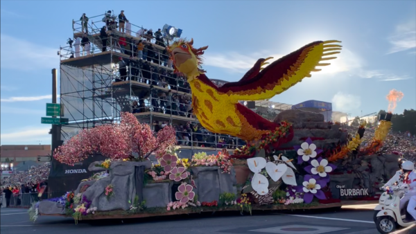 Giant gold phoenix spreads its wings from the Burbank Tournament of Roses Association float as it passes the reviewing stand