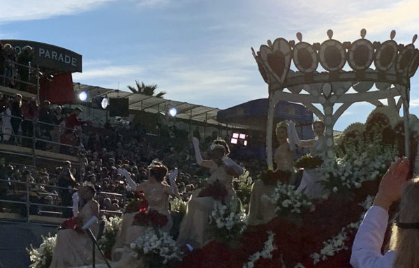 Rose Queen Camille Kennedy waves from top of giant "Crown" float with six Rose Princesses seated on steps leading up to her "throne"
