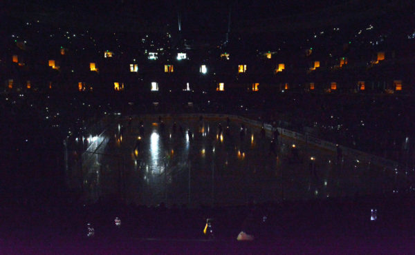 Anaheim Ducks with lighted helmets on ice with the lights down