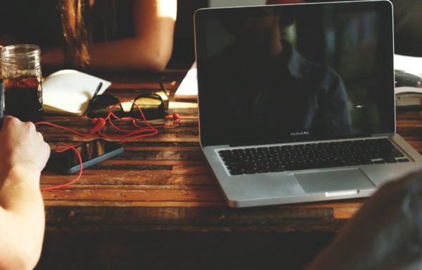 Laptop and red extension cord on a wooden desk