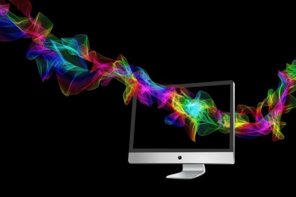 Particles in rainbowy light form a virtual garland through a desktop screen