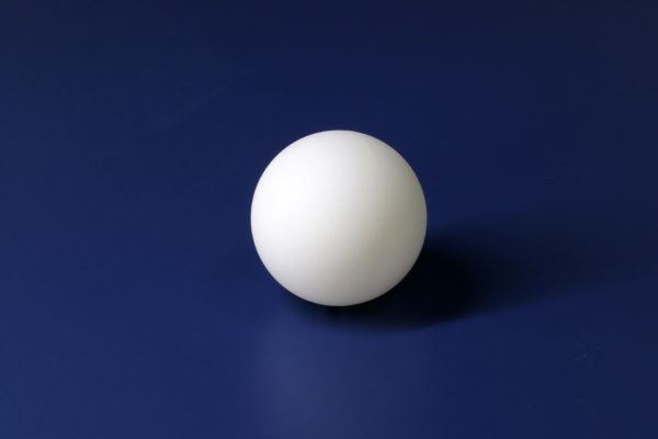 white ping pong ball on blue background