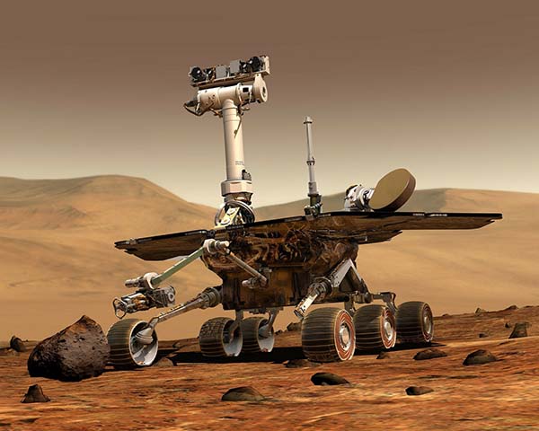 Mars rover, with camera arm extended, sits on Martian landscape.