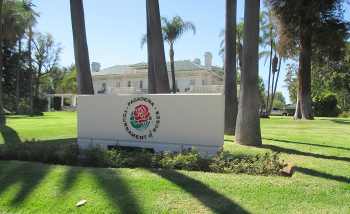 Tournament House, in Pasadena surrounded by palm trees and with "Pasadena Tournament of Roses" sign in front of it.