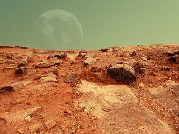 Red Martian landscape in closeup with a green sky and translucent image of Earth on the horizon