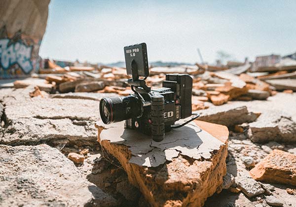 Video camera sits atop a rock in a desert landscape