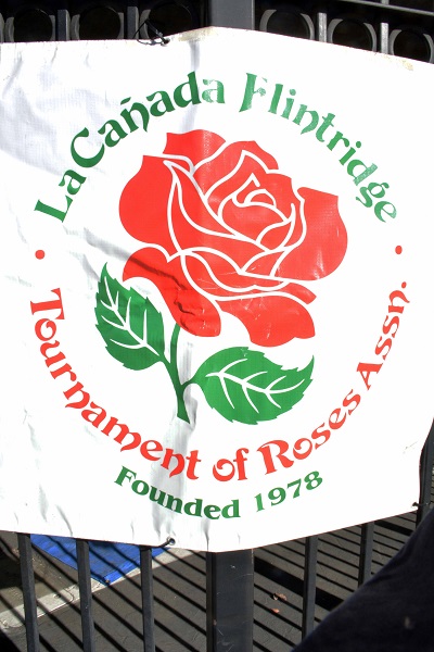 La Canada Flintridge Tournament of Roses emblem with their name surrounding a red rose.