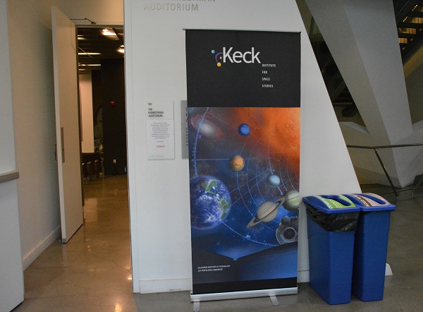 Keck Institute sign advertises AR and VR symposium next to white wall