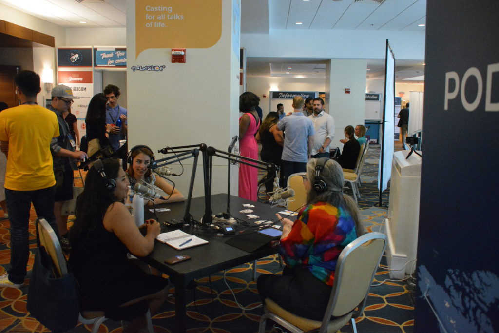 NextFab Assistant Sales Manager Anna Solomon and NextFab member/entrepreneur Jezabel Careaga talk with Over Coffee host Dot Cannon onsite at the Talkshoe pavilion during Podcast Movement 2018