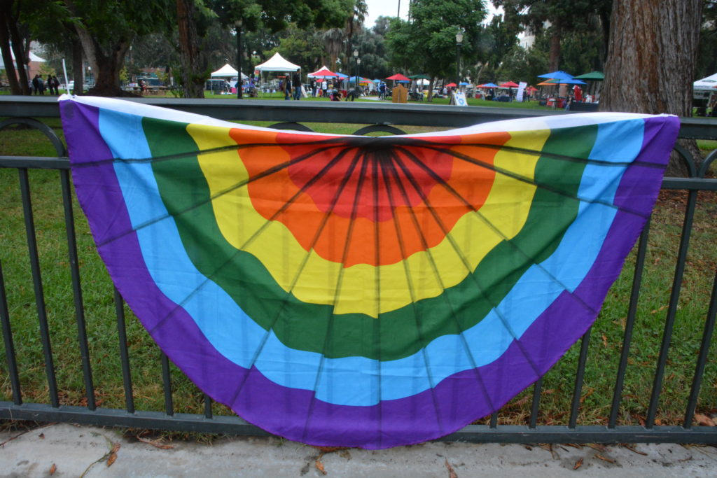 San Gabriel Valley Pride Festival 2018 tents in Pasadena's Central Park beyond rainbow bunting