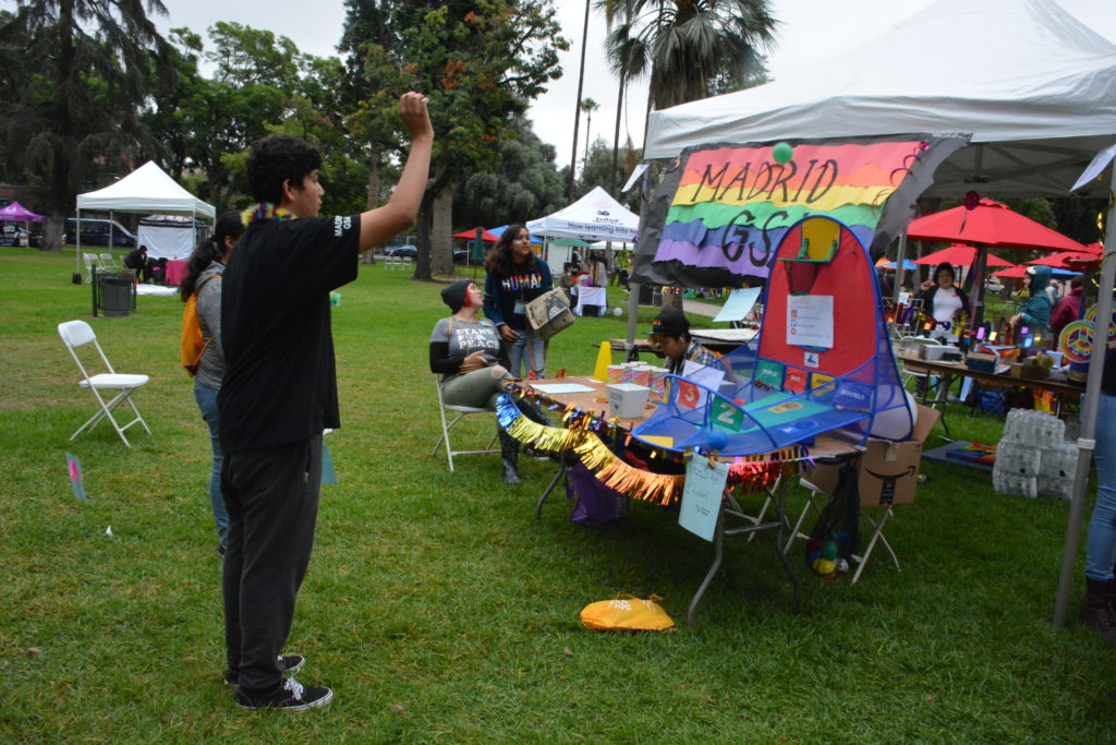 Visitor tosses a ball during a carnival game at SGV Pride in Pasadena's Central Park.