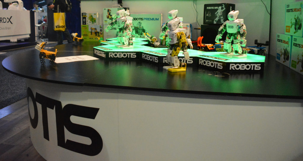 Robotis miniature humanoid robots dance on a counter at CES 2019