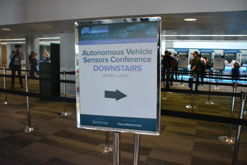 Sign with Sensors border advertises "Autonomous Vehicles Conference Downstairs"