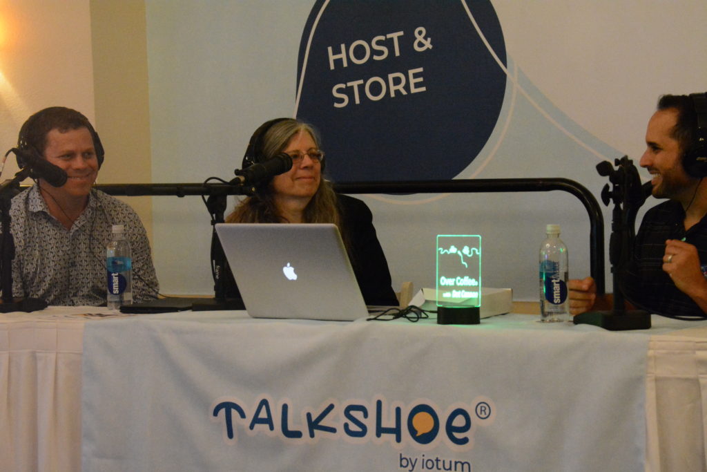 StangSat software mentor Kelvin Ruiz explains the design process as host Dot Cannon and StangSat lead mentor Shaun Daly listen at the Talkshoe pavilion.