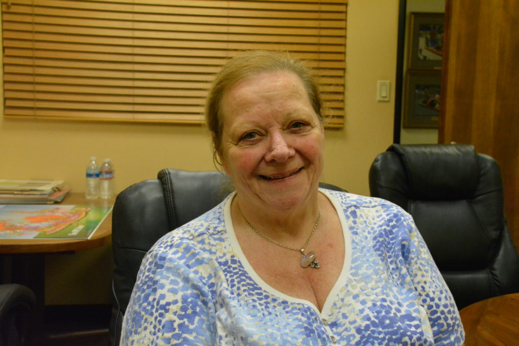 Fiesta Parade Floats Project Manager Beverly Stansbury smiles in conference room