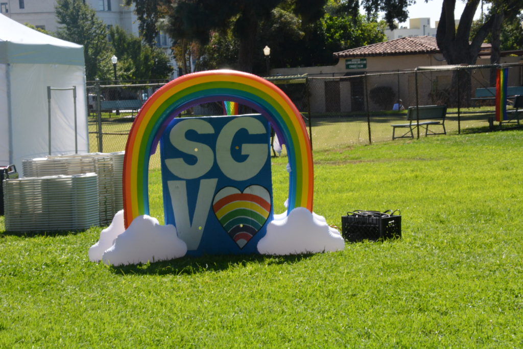 Inflatable rainbow with clouds and "SGV" under it