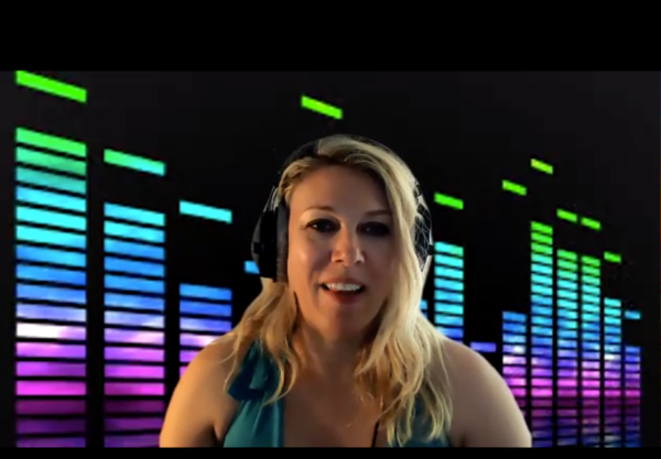 DJ Celeste Lear smiles in front of a multicolored light-meter background.