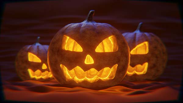 Three lit Jack-o-Lanterns with eerie grins and triangular eyes and noses