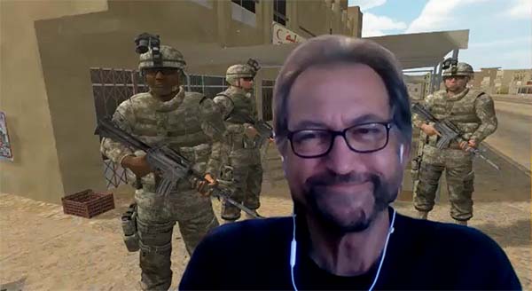 Dr. Albert "Skip" Rizzo smiles in front of a screenshot of his immersive VR application, BraveMind, designed to treat PTSD