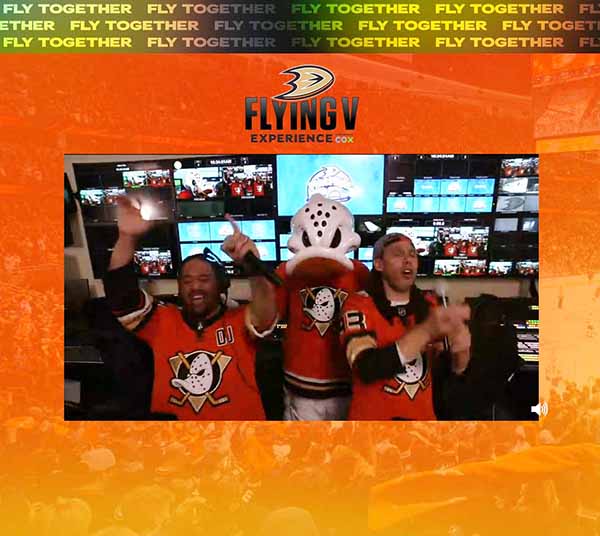 Jojo, Wild Wing and Sammy, near a bank of video monitors, put their hands in the air after receiving 250,000 taps