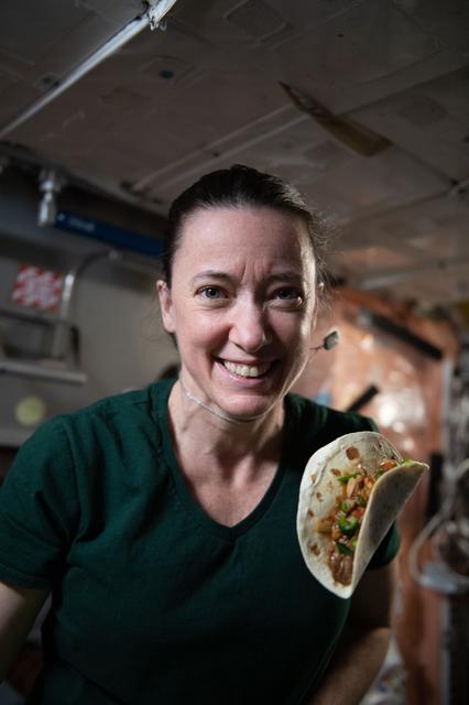 NASA astronaut and Expedition 66 flight engineer Megan McArthu smiles as a "space taco" floats before her on the ISS.