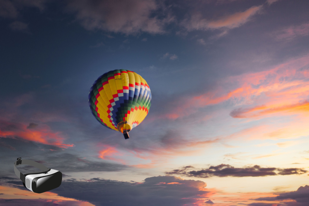 A small virtual reality headset in the lower corner of an image of a multicolored balloon flying into a sky lit with pink clouds