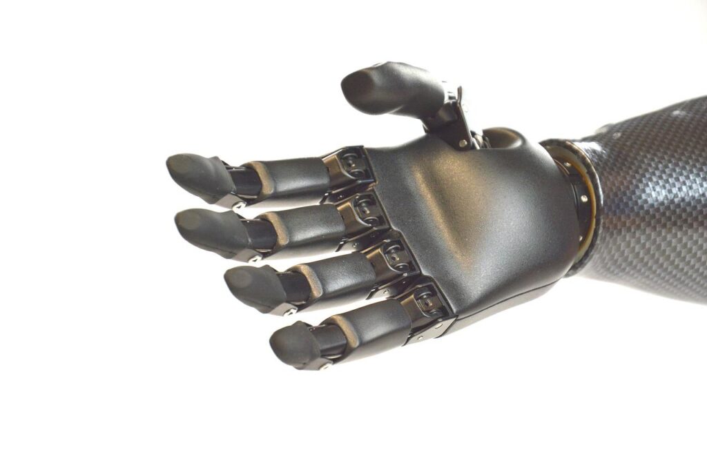 Silver robotic hand with fingers extended as if to shake hands