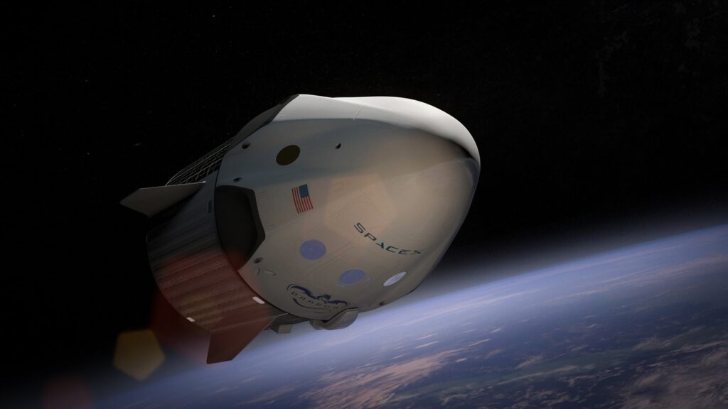 Cone-shaped spacecraft with American flag and "SpaceX" on it floating in space above earth