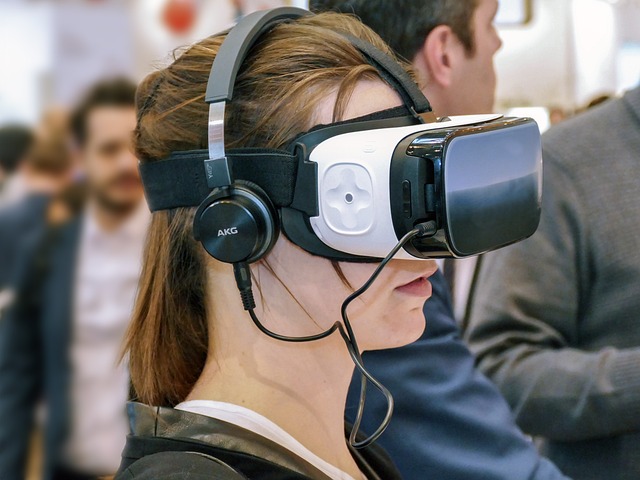 Woman looks into a VR headset with two men in the background