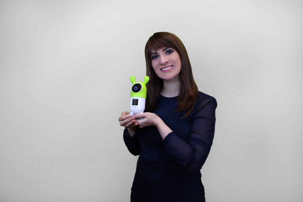 ROYBI Robot CEO and Founder Elnaz Sarraf holds her educational robot,, which is costumed in green plastic rabbit ears.