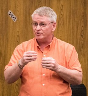 Author and "Attitude Chiropractor" Stephen Shaner performs a card trick during his magic show