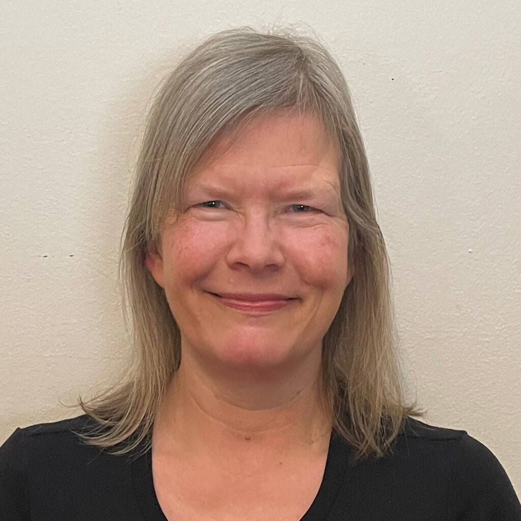 Author and Foremothers Cafe creator Helen Lundstrom Erwin smiles in a classic headshot.