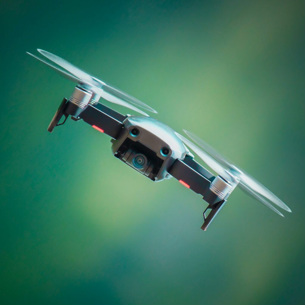 Drone shown flying against a green background.