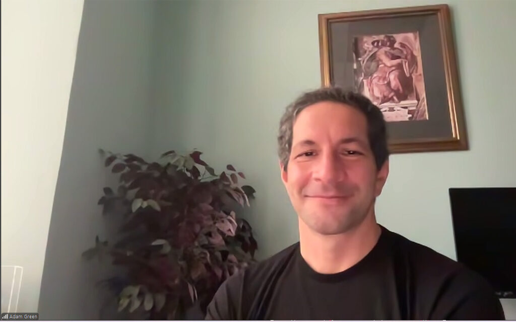 Society for the Neuroscience of Creativity Co-Founder Dr. Adam Green smiles against an office background.