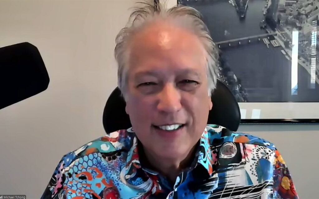Futurist, Ubertrends Founder and author Michael Tchong smiles as he discusses AI and "catching the next wave" of the future.