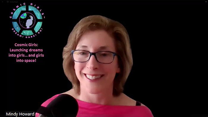 Cosmic Girls Foundation Founder and CEO Dr. Mindy Howard smiles against a black background as she speaks into a microphone.