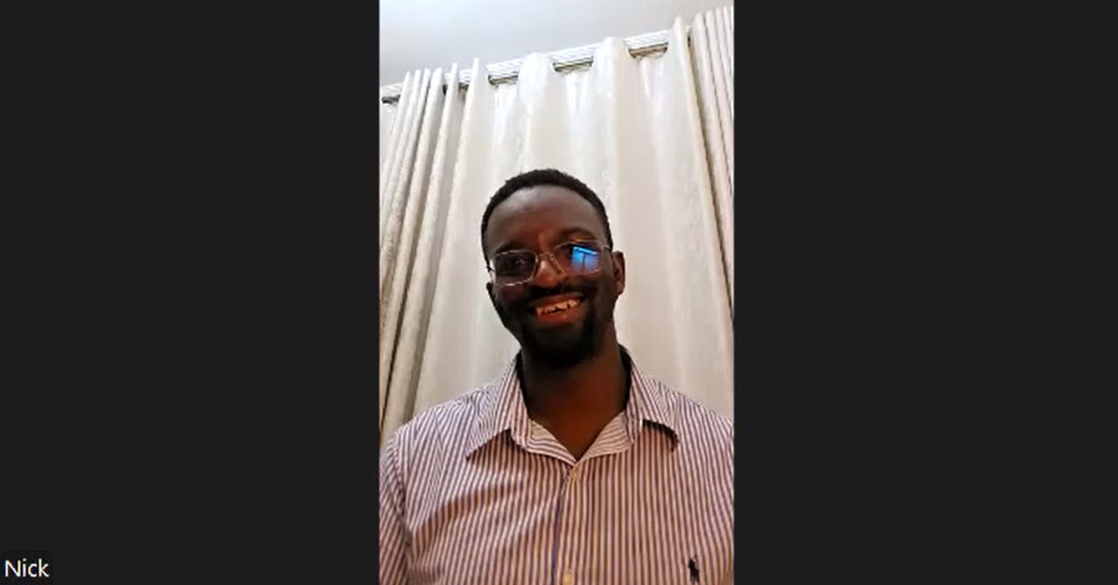 Prothea Kenya Co-Founder Dr. Nick Were smiles against a background of a white curtain