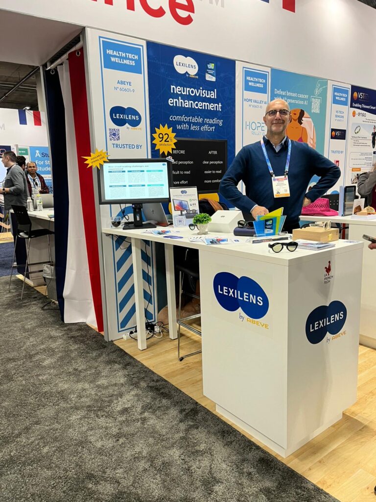 Michael stands behind a "Lexilens" display at CES 2026, in Las Vegas.