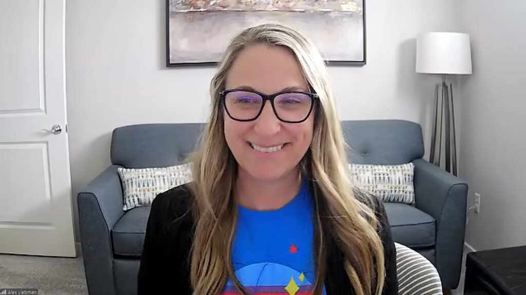 Las Vegas Science and Technology Festival Director Alexandra Liebman smiles against a Zoom background of her office.