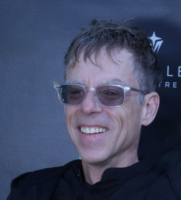 Futureproof Music School Founder and CEO John Von Seggern smiles against a blue-gray background