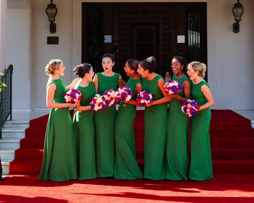 2027 Rose Queen Irene Maddox stands openmouthed after the announcement as her fellow Royal Court members surround her with expressions of surprise and joy.